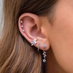 a close up of a woman's ear with flowers on it