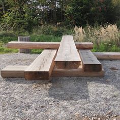 a wooden bench sitting on top of a gravel field