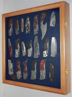 a display case with many different types of knifes on the inside and outside of it