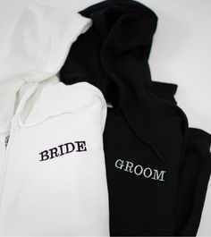 three black and white hoodies with the bride and groom embroidered on them, sitting next to each other