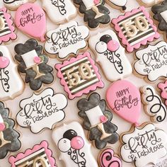 decorated cookies are displayed on a table for someone's 30th birthday party in pink and black