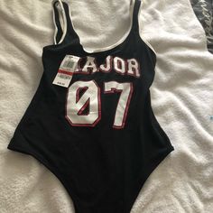 Brand New Letter Print Swimwear For Swimming, Casual Stretch Bodysuit For Poolside, Trendy Black Sleeveless Swimwear, Black Letter Print Swimwear For Summer, Black Graphic Print Swimwear For Swimming, Black Graphic Print Swimwear, Sporty Cotton Bodysuit For Summer, Trendy Black Bodysuit For Beach Season, Casual One-piece Cotton Swimwear