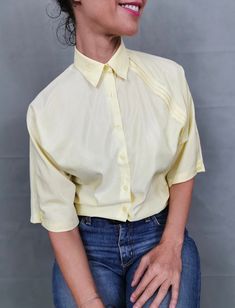 "Vintage blouse for women size S | Light yellow blouse with front pleats. Very cute blouse, great for summer. Composition: 65% cotton, 35% polyester. Size on tag: 36. Measurements of the vintage blouse for women lying flat: Armpit to armpit: 50 cm | 19.7\" Length: 60 cm | 23.6\" Shoulders: 40 cm | 15\" In excellent vintage condition. My shop is dedicated to vintage blouses exclusively, so have a look for more beautiful options: https://etsy.me/2PovJic" Cheap Vintage Yellow Shirt, Cheap Yellow Semi-stitched Blouse, Vintage Blouses, Vintage Blouse, Cute Blouses, Yellow Blouse, Blouse For Women, Blouse Vintage, Light Yellow