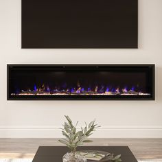 an electric fireplace with blue flames in the middle and white walls behind it, along with a black coffee table