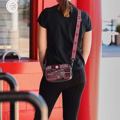 Over your shoulder and off to the game. Whether you're running errands on the town or running the tailgate in the parking lot, this Alabama Crimson Tide Repeat Retro Print Clear Crossbody Bag is the perfect way to carry the team like never before. Features Repeat Alabama Crimson Tide current and retro team logo and wordmark displays on sides of bag, in case there were any doubts where your allegiances lie Woven, team-colored crossbody strap that makes carrying the team easy and convenient Repeat Red Crossbody Bag With Silver-tone Hardware, Alabama Crimson, Crimson Tide, Alabama Crimson Tide, Retro Prints, Team Colors, Running Errands, Alabama, Crossbody Bag