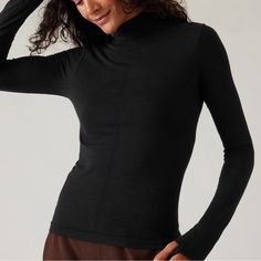 Athleta Ascent Seamless Turtleneck. Size Small. New With Tags. For: Commute, Travel, Hiking In Cold Weather Climates Feel: New And Improved Merino Wool Yarn Is Ultra-Soft, Lightweight, And Resists Pilling Fave: Pointelle Stitching Down The Front For Breathability Close-To-Body Fit Make It The Perfect Base Layer Light Mesh Structure On Back Facilitates Ventilation Wool/Nylon Seamless: Beyond-Soft, Chafe-Free Fabric Stretches With Every Move Breathable: Airflow Moves Easily Through The Garment Machine Wash And Lay Flat To Dry. Fitted Next To The Body Regular Length, Hits At Low Hip T-Neck Body Length In Size Medium: Regular: 22" Functional Stretch Tops For Layering, Seamless Fitted Activewear For Layering, Black Moisture-wicking Activewear For Layering, Black Athleisure Activewear For Layering, Stretch High Neck Tops For Yoga, Stretch High Neck Yoga Tops, High Neck Stretch Tops For Yoga, High Neck Stretch Yoga Tops, Stretch Activewear With Thumbholes For Layering