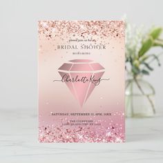 a pink and gold glitter bridal shower card with a diamond on the front, it is