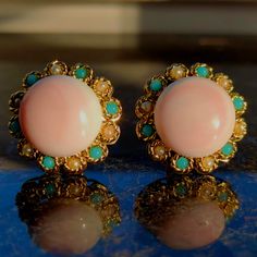 When ordering, please give us your phone number for safer Fedex shipping!Earrings Size: 25 mm Metal Type: 18k gold Weight: 25.9 grams Natural coral: 17mm diameter x 6mm tall Condition: excellent  Step into the world of vintage elegance with these Vintage 1960s Angel Skin Coral, Turquoise, and Pearl Statement Round Stud Earrings. These earrings are a testament to the timeless charm of the 1960s, featuring a beautiful combination of Angel Skin Coral, Turquoise, and Pearl. The earrings showcase a r Pink Vintage Earrings For Anniversary, Retro Pink Jewelry For Formal Occasions, Pink Retro Style Jewelry For Formal Occasions, Vintage Turquoise Earrings With Round Beads, Formal Pink Round Clip-on Earrings, Retro Round Cabochon Jewelry, Retro Cabochon Jewelry, Retro Round Earrings For Anniversary, Vintage Turquoise Round Earrings