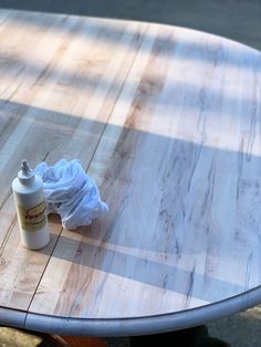 a table that has some kind of cloth on it and a bottle next to it