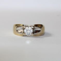 0257  This ring would make the perfect everyday ring or to make a statement. Set in yellow gold with a white gold head and a beautiful white cz stone set in the middle for that extra sparkle.  Sizing:  UK: K 1/2 US: 5 1/4 Continental: 10 This is a vintage item and such has wear. There may be some superficial scratches, otherwise the item is good condition. This item comes beautifully boxed in our own packaging. Processing time for orders is 1-3 business days. Modern White Topaz Diamond Ring In Yellow Gold, White Diamond Ring With Brilliant Cut For Promise, White Timeless Ring With Tension Setting, White 14k Gold Ring With Brilliant Cut, Timeless White Ring With Tension Setting, White 14k Gold Rings With Brilliant Cut, 14k Gold Diamond Ring With Tension Setting In Silver, White 14k Gold Diamond Ring With Vvs Clarity, Modern White Wedding Ring With High Clarity