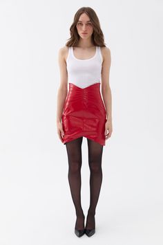 You'll find endless possibilities for styling this chic patent faux leather mini skirt. It features a slim fit, lining, metal zipper closure, cup detail, and a high-waisted corset design. Spot Clean Material: 57% Polyurethane 43% Polyester High rise Officially licensed Imported Brand: Nocturne Model Product Size: S Model Size: Height 5'10 / Bust 29.5 in / Waist 23 in / Hips 34 in Runs smaller order one size up. Please check the size chart before placing your order. Cheap Red Lined Mini Skirt, Faux Red Leather Skirt, Chic Stretch Mini Skirt At Cheap Price, Faux Leather Skirt Red, Plus Size Red Mini Skirt, Red Leather Mini Skirt, Corset Design, Balloon Skirt, Belted Mini Skirt