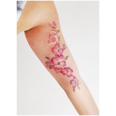 a woman's arm with pink flowers on it