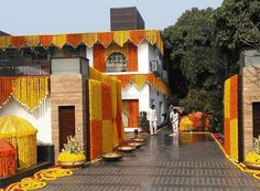 an entrance to a building decorated with yellow and orange decorations