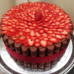 a large chocolate cake with strawberries on top