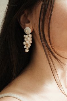 The Anita Berisha Mini Mermaid Earrings were inspired by earths layers, oceans, rocks, and minerals, a tribute to our precious planet. The Mermaid Earrings are meticulously handcrafted using seashells and freshwater pearls, using 24K gold-plated posts. Each Earring set is unique due to the organic nature of the pearls. Seashells Freshwater Pearls 24K Gold Plated Posts The Seashell Earring: approx. 2.5 inches long The Stud Pearl Earring: approx. 2 inches long Each earring set is unique due to the Ocean-inspired Pearl Drop Earrings, Elegant Pearl Shell Jewelry, Elegant Pearl Shell-shaped Jewelry, Unique White Pearl Earrings For Wedding, Unique Beaded Wedding Earrings, Ocean-inspired Pearl Drop Earrings As A Gift, Pearl Shell Jewelry For Weddings, Pearl Shell-shaped Wedding Jewelry, Elegant Shell Jewelry With Natural Stones