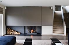 a living room with a fire place and stairs