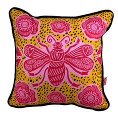 a yellow and pink pillow with a bee on it