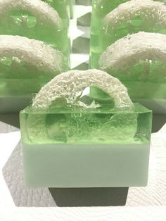 some green and white soaps sitting on a table