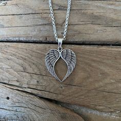 "Angel wing heart necklace....1 1/2\" tall with bail by 1 1/16\" wide at the widest spot, cast and antiqued in sterling silver 925...great detail, the chain is 20\" long also in sterling silver 925 with a lobster catch" Heart-shaped Oxidized Sterling Silver Necklaces, Heart-shaped Sterling Silver Necklace With Oxidized Finish, Heart Shaped Sterling Silver Necklace With Oxidized Finish, Silver Winged Engraved Jewelry, Silver Engraved Wing-shaped Jewelry, Silver Heart Pendant Jewelry With Oxidized Finish, Silver Oxidized Heart Pendant Jewelry, Engraved Winged Sterling Silver Jewelry, Engraved Wing-shaped Silver Jewelry