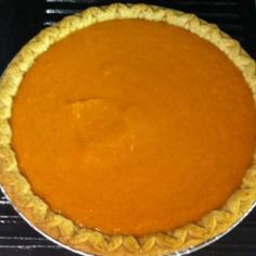 a pumpkin pie sitting on top of a stove