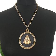 "Amazing glass and gold gilt metal medallion necklace. Signed 'Art' (Arthur Pepper).  Circular glass with gold plated metal decorative star surround, central metal pharaoh attached with a drilled rivet and signed on the back, gold-plated engraved chain and foldover clip fastening. Genuine original item - collectable and quite rare. 7\" diameter pendant 18\" chain Condition - age wear to gold plating, which has faded particularly on the chain and clasp, but this necklace is still in great condition for its age. The glass was thick with dust when I received it and I've given it a new lease of life." Bronze Medallion Jewelry With Large Pendant, Symbolic Brass Medallion Necklace, Gold-tone Metal Medallion Necklace With Coin Pendant, Gold-tone Metal Medallion Necklace, Gold-tone Medallion Metal Necklace, Gold-tone Medallion Amulet Necklace, Gold Collectible Medallion Necklace, Gold-tone Medallion Necklace In Amulet Style, Gold-tone Medallion Necklace