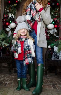 a woman and her daughter standing in front of a christmas tree with the words trove on