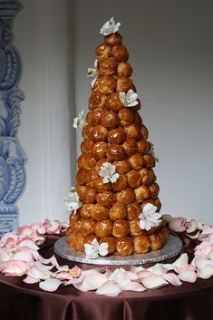 there is a very tall cake made out of donuts