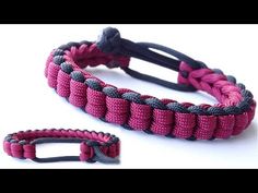 a pink and black paracorine bracelet with an adjustable clasp on the end, sitting next to a white background