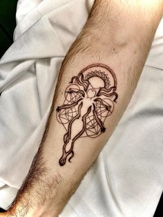 a man's arm with a tattoo on it that has an image of a woman holding