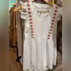 White Baby Doll Shirt With Embroidered Embellishment White Embroidered Short Sleeve Top, Cute White Blouse With Floral Embroidery, White Cotton Top With Embroidered Hem, White Cotton Embroidered Top With Embroidered Hem, White Cotton Blouse With Embroidered Hem, White Cotton Embroidered Top With Hem Detail, Fitted White Embroidered Top With Embroidered Hem, White Fitted Embroidered Top With Embroidered Hem, White Short Sleeve Top With Embroidered Hem