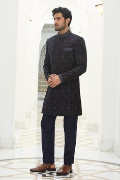 Midnight blue velvet short sherwani embroidered in a resham jaal overlaid with tonal beads, dabka and crystals. Paired with a kurta and churidar.
Components: 3
Pattern: Embroidered
Type Of Work: Resham, Bead, Dabka, Crystal
Neckline: Band collar
Sleeve Type: Long
Fabric: Velvet, Viscose Cotton
Color: Blue
Occasion: Sangeet - Aza Fashions Designer Blue Sherwani With Dabka Details, Blue Long Sleeve Sherwani With Dabka Details, Blue Fitted Sherwani With Resham Embroidery, Blue Embroidered Long Sleeve Sherwani, Fitted Black Embroidered Sherwani, Short Sherwani, Velvet Shorts, Band Collar, Custom Tailoring