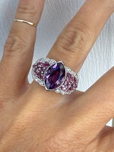 This genuine amethyst measures 12mm x 7.5mm. There is approximately .60ctw of genuine pink tourmalines on the side, and there are genuine diamonds of approximately .18ctw H/SI1-I1 The head of the ring measures 14mm at the widest point.  It tapers to 2mm at the very back of the shank. The ring weighs 6.1g. It is stamped 14K white gold.  The ring is currently a size 8 and sizeable. We are happy to provide sizing for an additional charge. Let me know if you need a quote. Luxury Pink Amethyst Ring With Accent Stones, Luxury Pink Amethyst Ring For Anniversary, Pink Luxury Amethyst Ring For Anniversary, Luxury Pink Amethyst Anniversary Ring, Pink Multi-stone Amethyst Ring, Pink Amethyst Ring For Formal Occasions, Luxury Pink Amethyst Gemstone Ring, Luxury Pink Amethyst Ring With Prong Setting, Formal Pink Amethyst Ring With Gemstone Accents