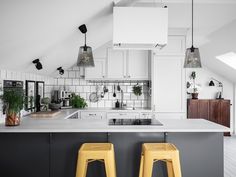 two yellow stools are in front of the kitchen counter