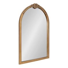 a mirror that is sitting on top of a table with a wooden frame and gold trimming