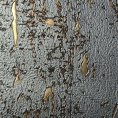 the texture of an old metal surface with gold and black paint on it, as seen from above