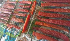 several skewered meats are on a wire rack and ready to be cooked