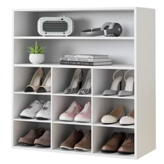 a white bookcase filled with lots of shoes next to a plant and air conditioner