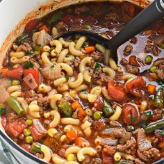 a large pot filled with pasta and vegetables