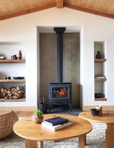 a living room filled with furniture and a fire place in the middle of it's walls