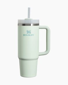 a white travel mug with a straw sticking out of it's side and the stanley logo on top