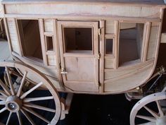 a wooden horse drawn carriage on display