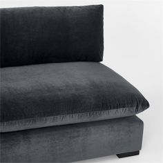 a black couch with a pillow sitting on it's back and the seat upholstered