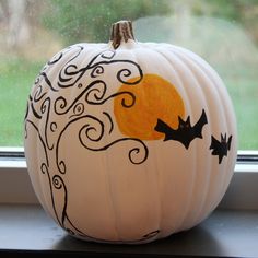 a painted pumpkin sitting on top of a window sill