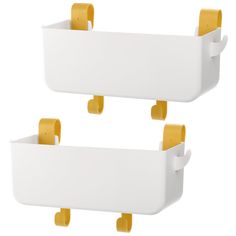 two white storage bins with yellow handles on each side, one holding toilet paper