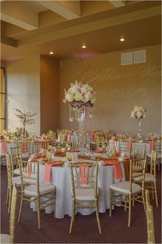 the tables are set up with white and pink linens for an elegant wedding reception