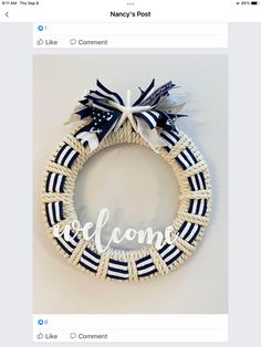 a white and blue wreath with the word welcome on it