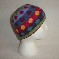 a white mannequin head wearing a multicolored knitted beanie hat