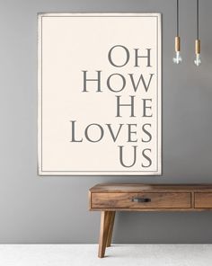 a poster hanging on the wall next to a wooden table with two lights above it