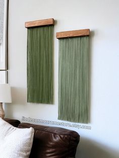 two green curtains are hanging on the wall