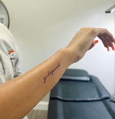 a woman's arm with a tattoo that reads, i love you in cursive writing